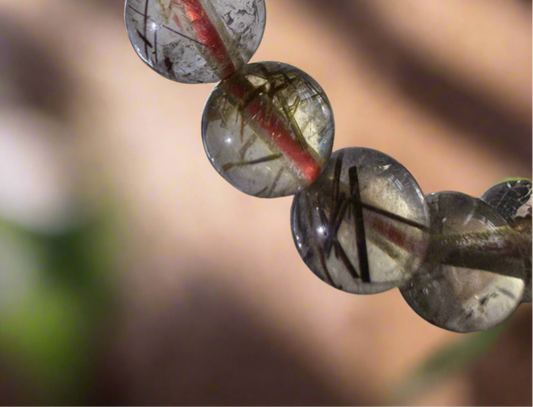 Rutilated quartz bead bracelet, close-up.