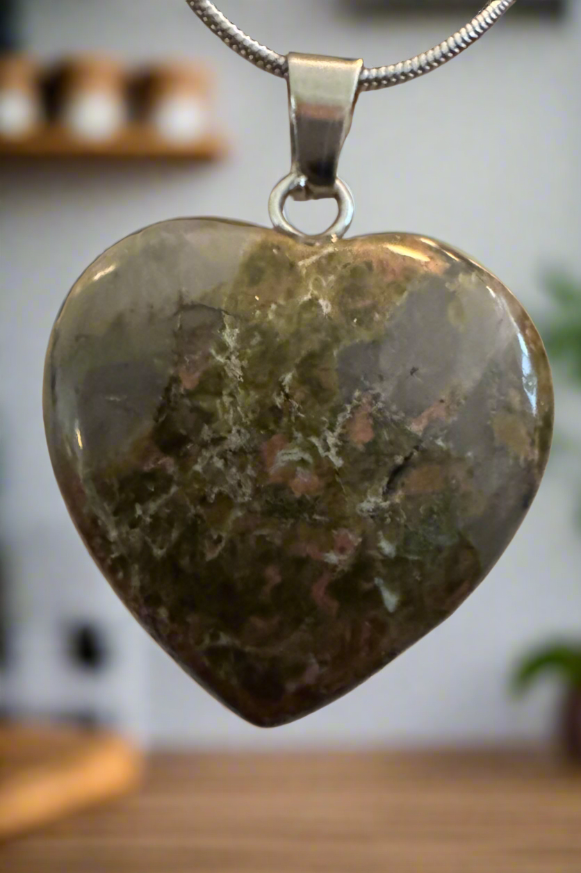 Heart-shaped unakite pendant on a silver chain.