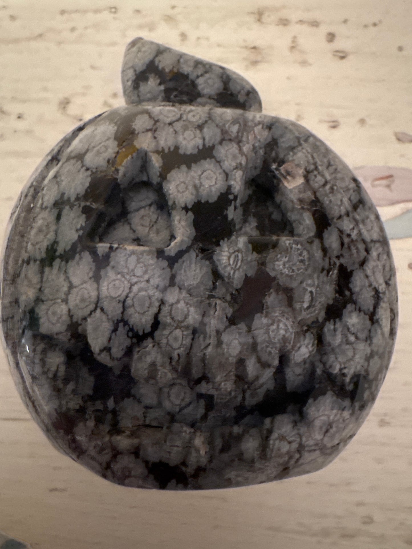 Carved snowflake obsidian pumpkin with stem.