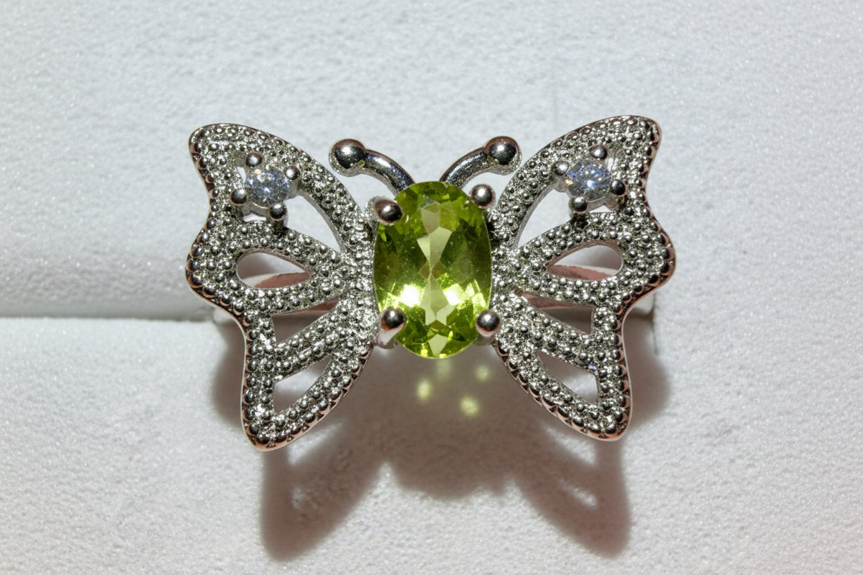 silvery butterfly ring with peridot stone and rhinestones