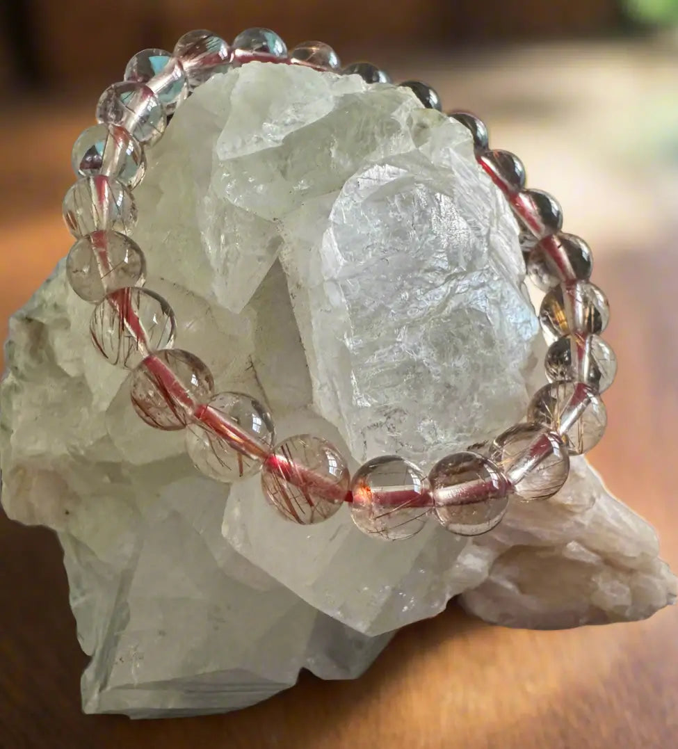 Beaded bracelet on a large rock.
