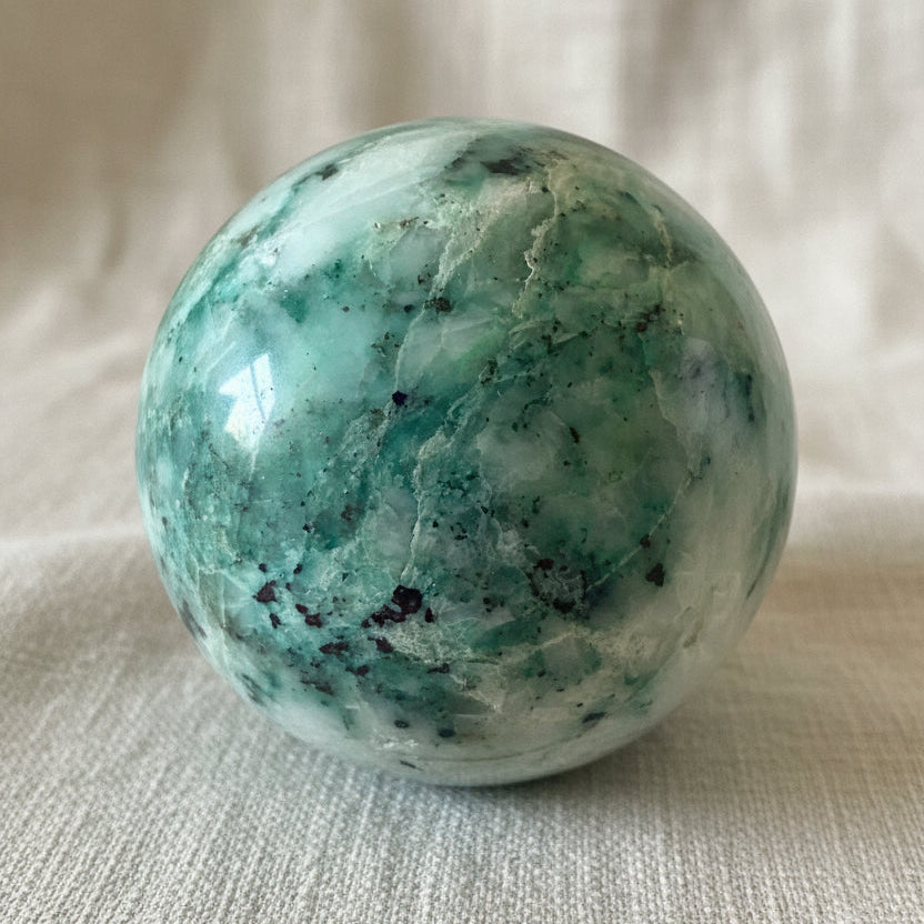 close up of chrysocolla sphere showing blues and quartz