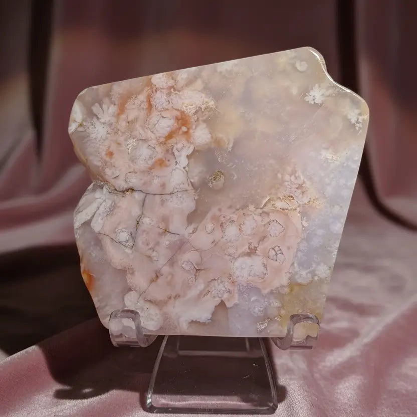 A polished flower agate, pink and white stone with coral-like patterns.