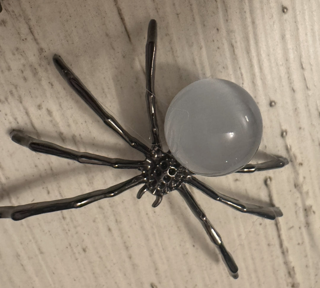 Metal spider figurine with translucent orb body.
