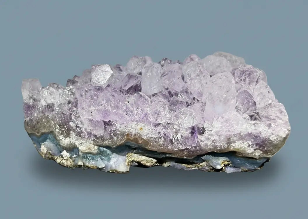Amethyst crystal cluster on a white background