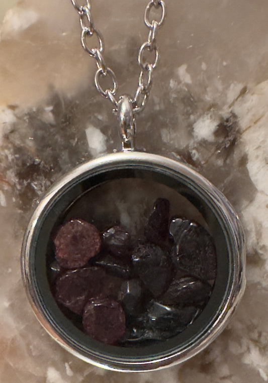 Silver and glass round locket filled with crystals locket on a silver chain