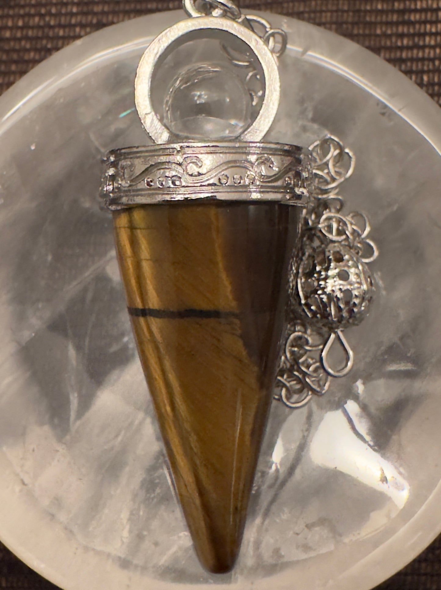 Tiger's eye pendulum with silver filigree.