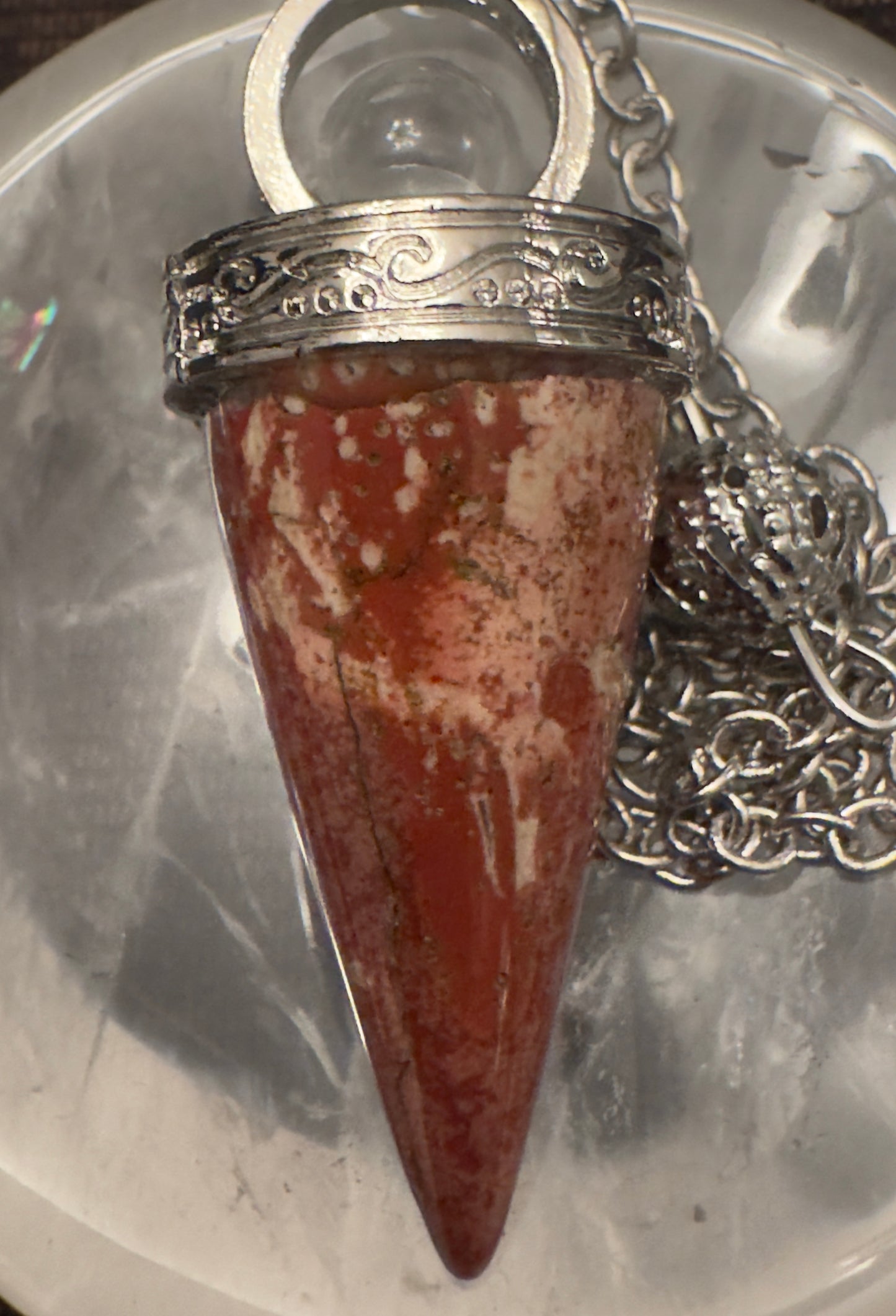 Red and white jasper pendant with silver setting and chain.