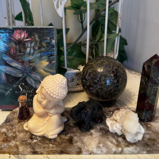 Decorative setup with Dragons Blood Crystals Raw Specimen Buddha Statue Elephant Agate Slab