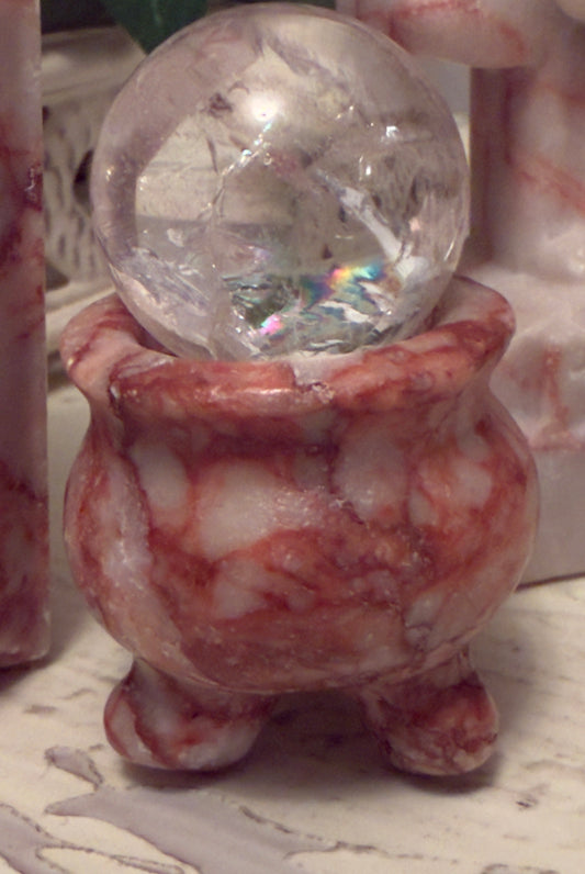 Crystal ball in a marble bowl.