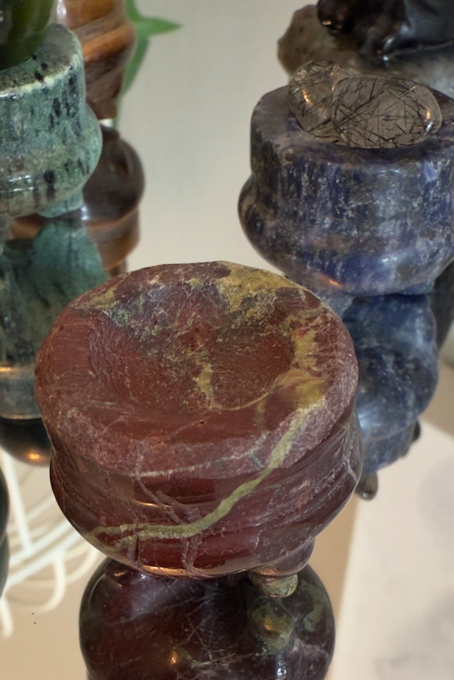 Close-up of stone chess pieces on a checkered board