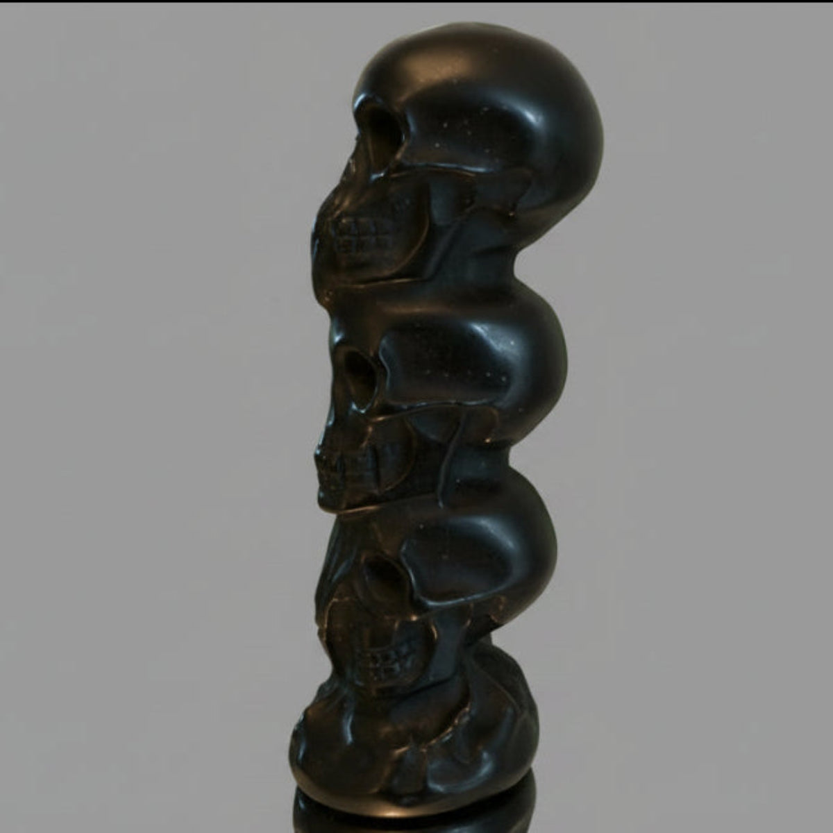 Black Obsidian Three Wise Skulls totem carving close-up