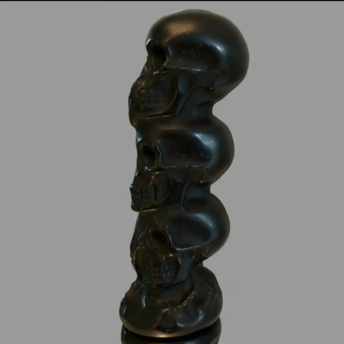 Black Obsidian Three Wise Skulls totem carving close-up