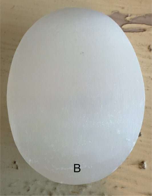 Oval white stone with letter B.