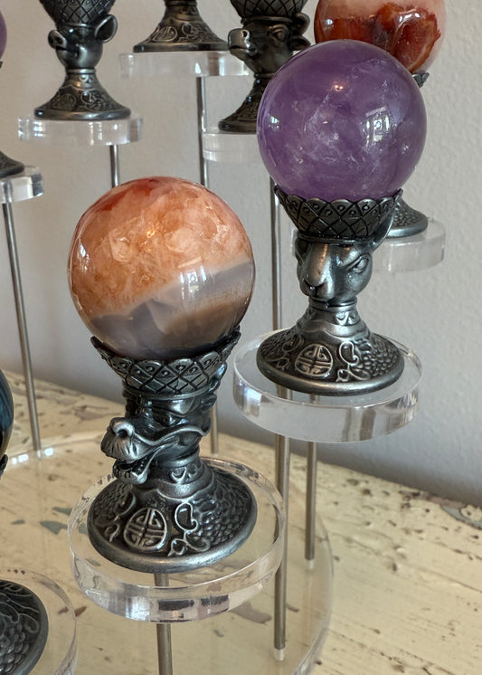 Close up of stainless Chinese Zodiac Sphere Holder Dragon and Monkey