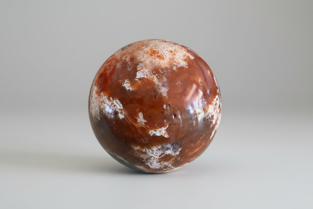 Close up of Brecciated Jasper Apatite Sphere beautiful orange colors
