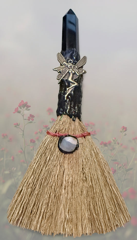 Hand crafted Besom Altar broom decorated with gold tone fairy charm black obsidian finial background muted red flowers