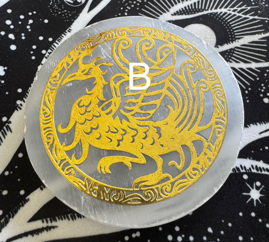 Round selenite disc with golden phoenix cutout and the letter "B" superimposed.