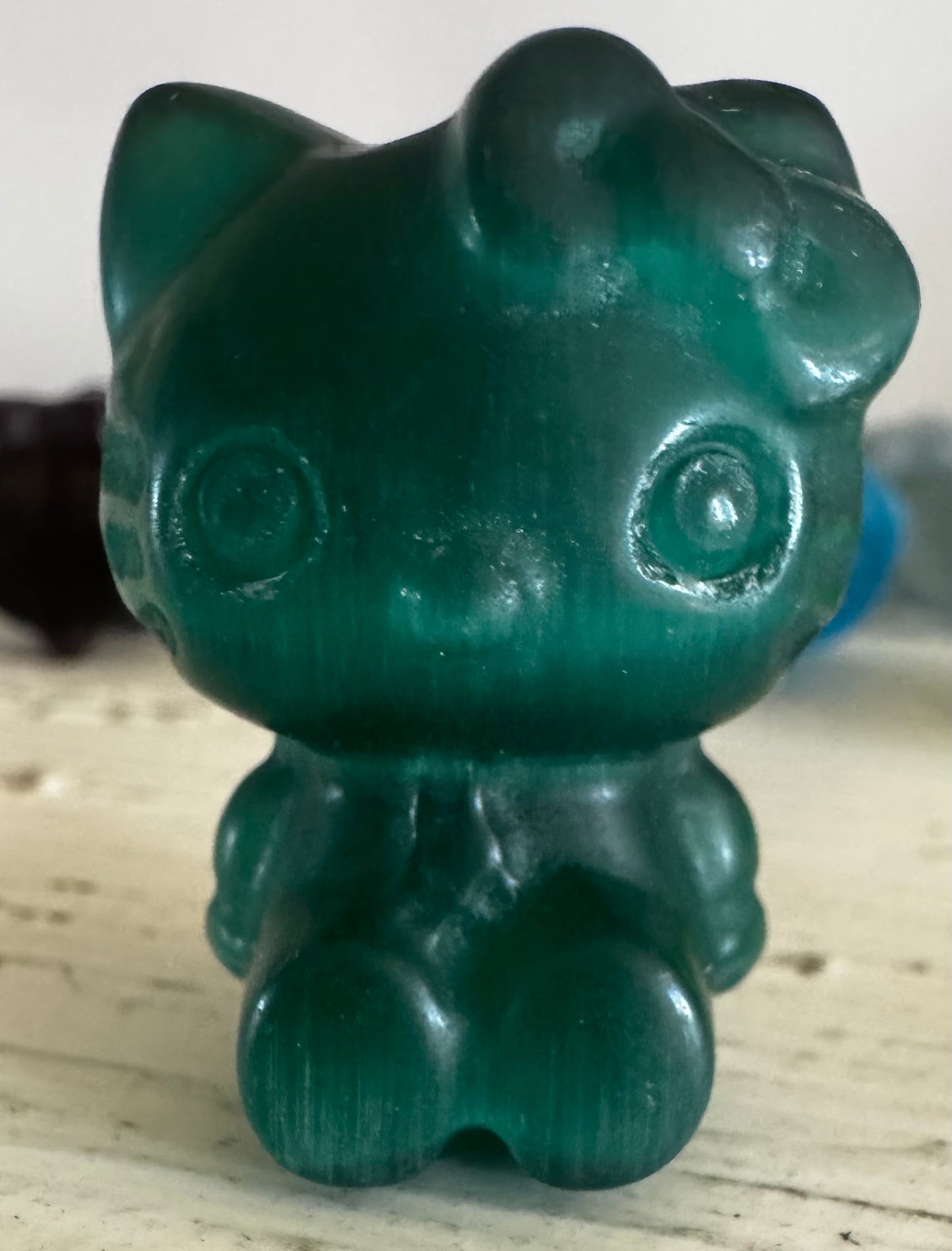 Green translucent Hello Kitty figurine.
