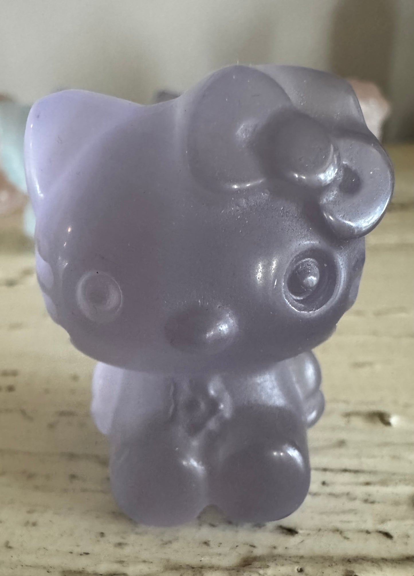 Close-up of a lavender Hello Kitty figurine.