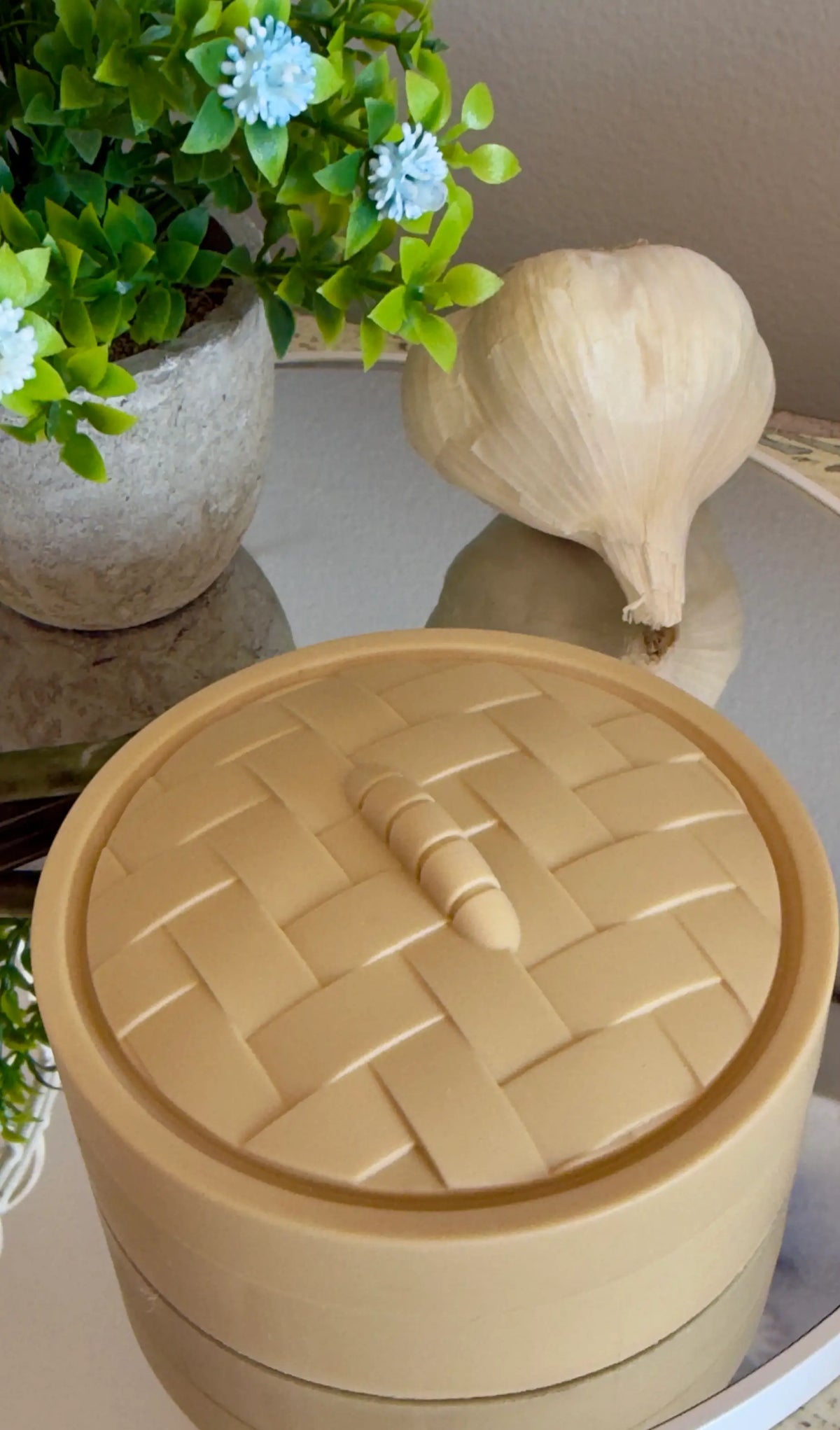 Asian Dumpling Steamer Basket C with lid closed, beige on a mirror surface