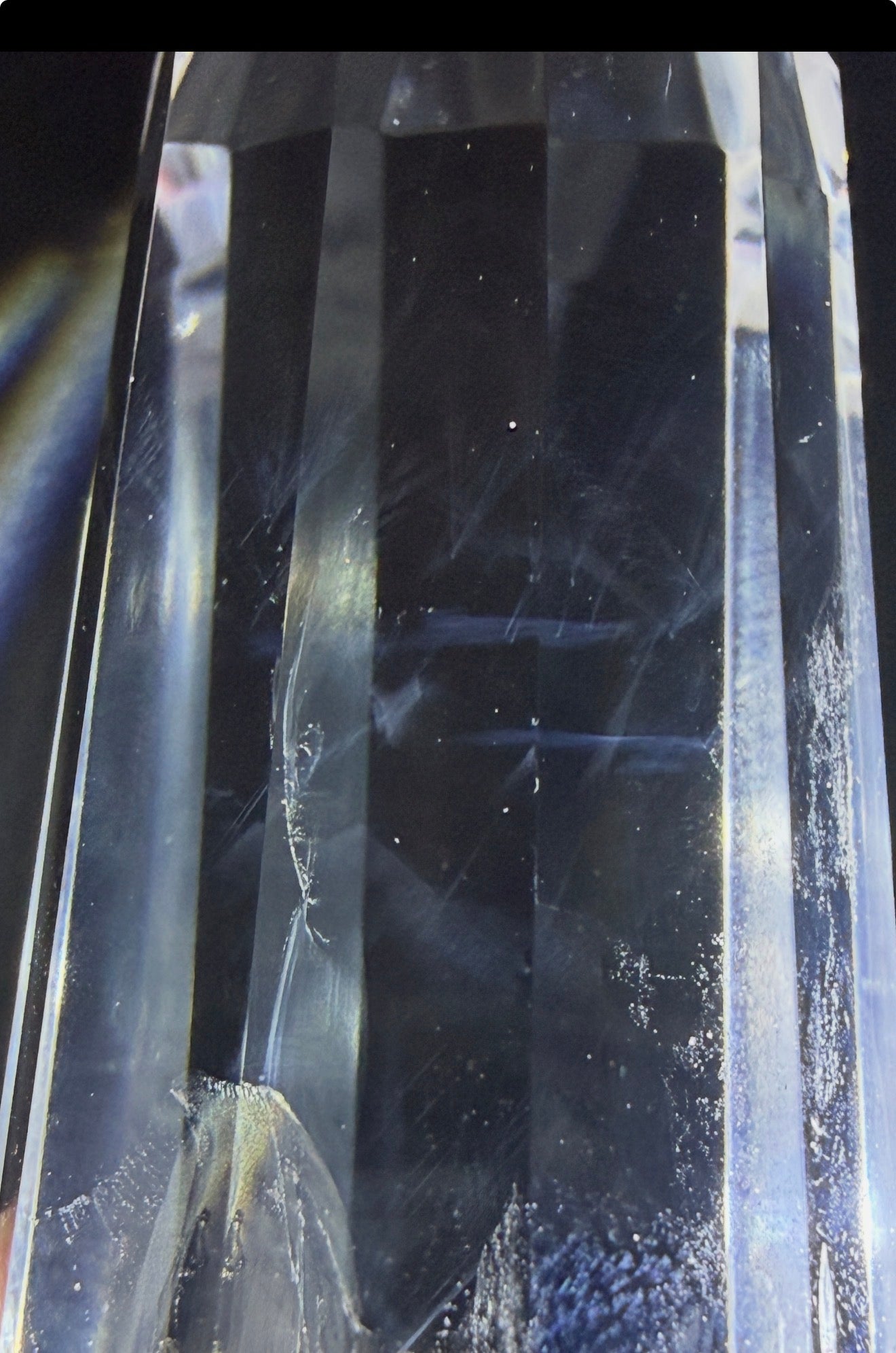 Close up of a clear quartz high quality double point prism with blue needle inclusion