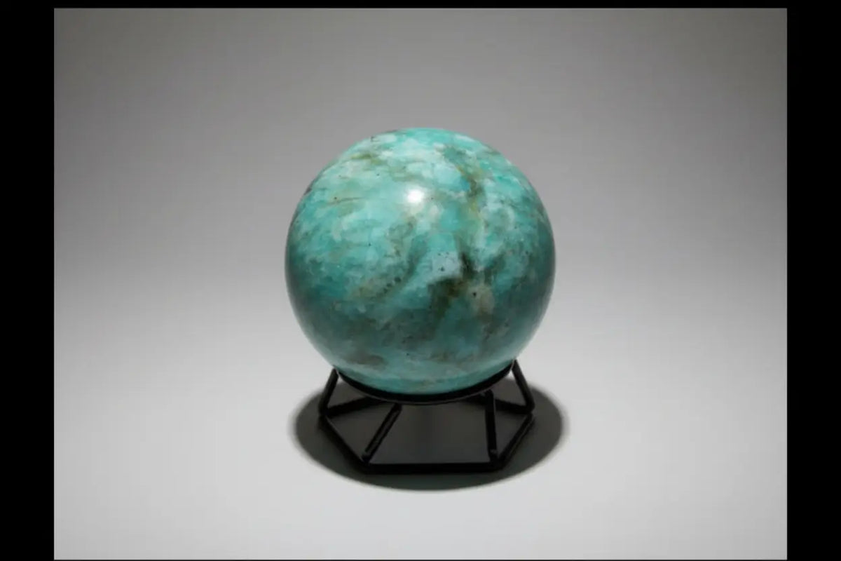 Amazonite Sphere colors teal, green, ivory sphere on a small stand with no background