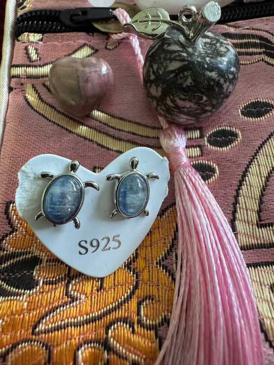 Earrings, pink tassel, two stones, patterned cloth.