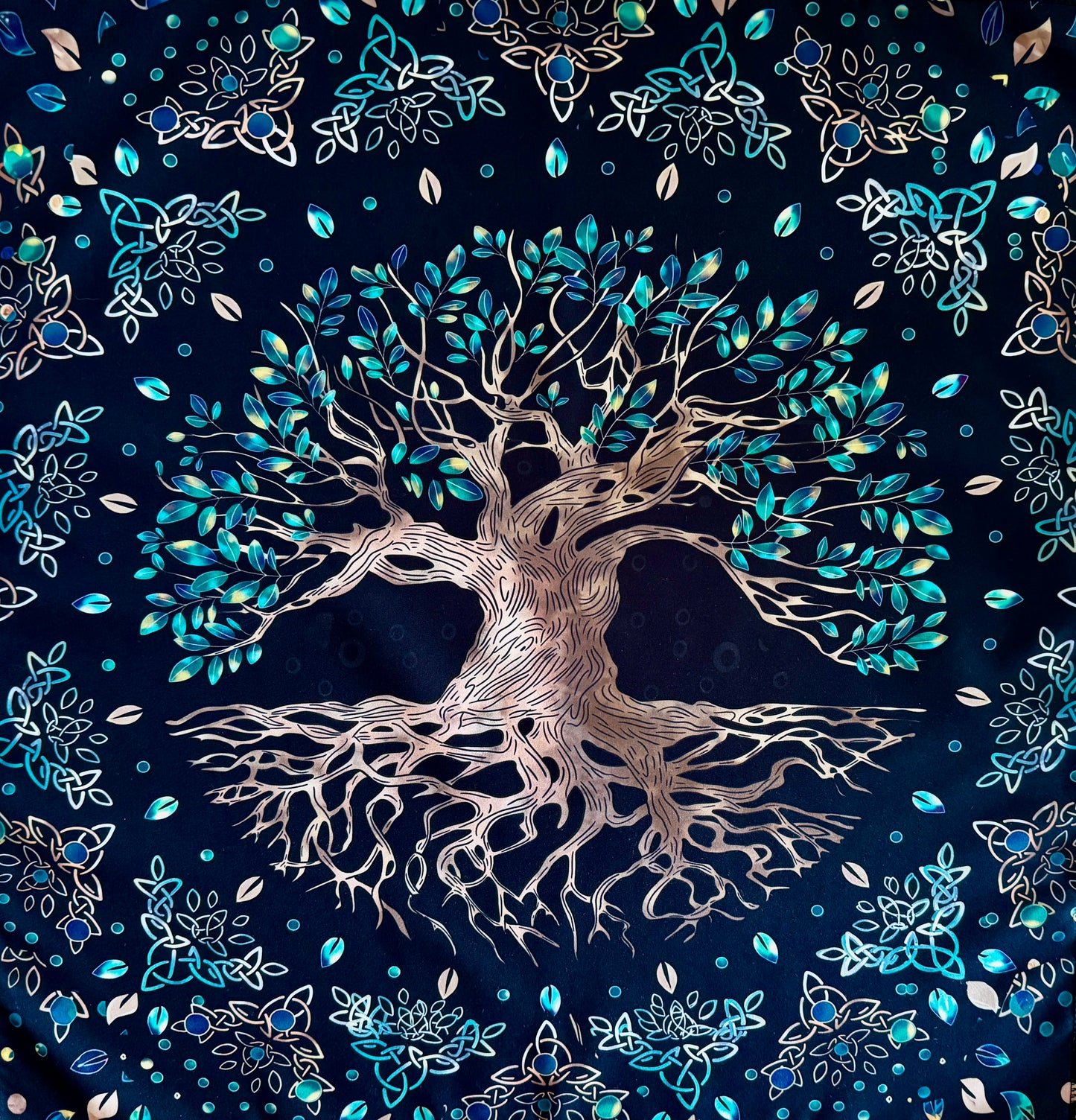 Black fabric tapestry featuring a large tree with leaves and celtic knot designs.