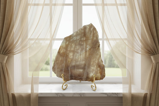 Banded Calcite Slab browns and tans in a window sill with curtains