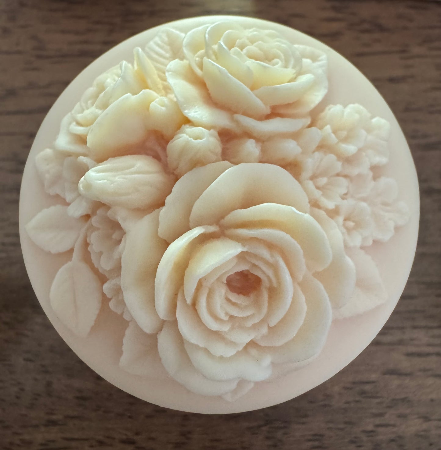 Round decorative soap with floral carvings.