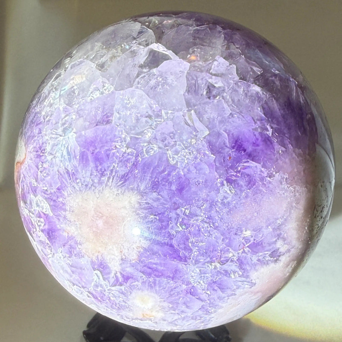 close up photo of amethyst sphere with natural inclusions