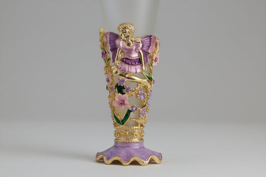 close up of fragrance bottle showing pink and purple fairy with flowers and rhinestones frosted bottle