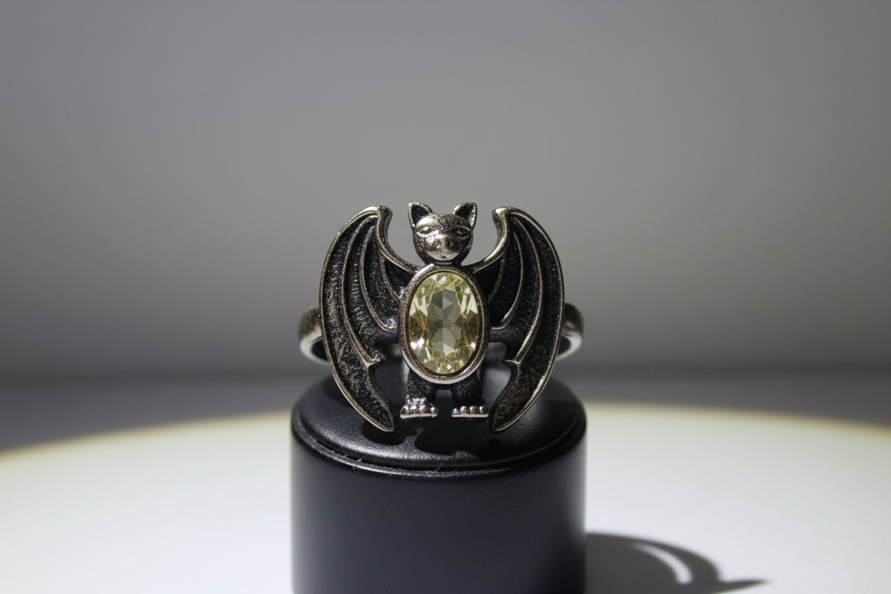 black alloy metal ring shaped like a bat has black coating and genuine crystal