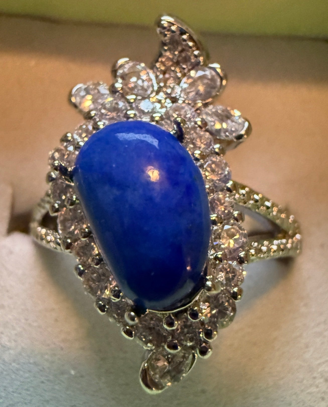 Close-up of blue lapis lazuli stone ring with rhinestones