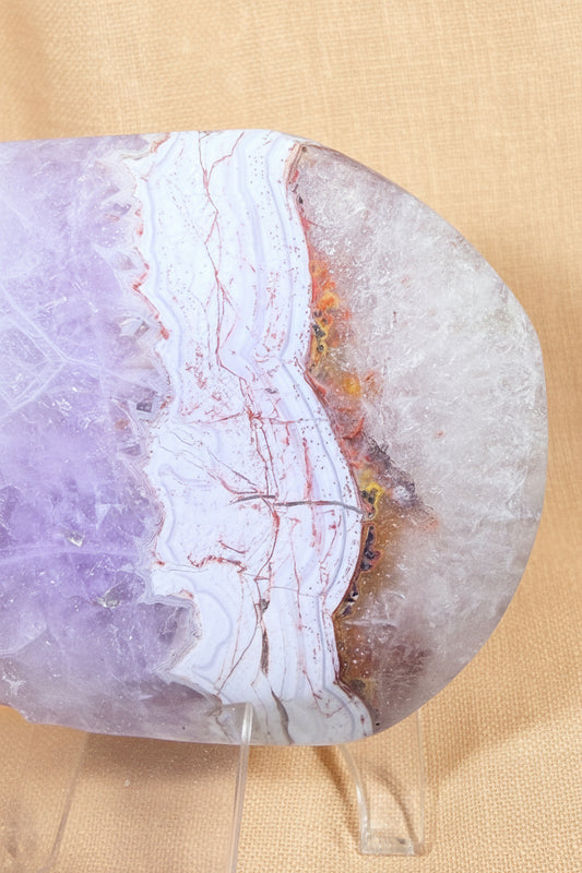 close up of a lepidolite and tourmaline large palm stone purple, iron / iron oxide inclusions