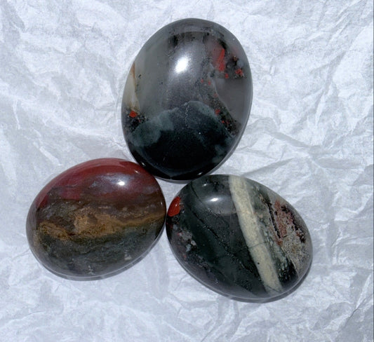 three bloodstone palms tones close up with white background