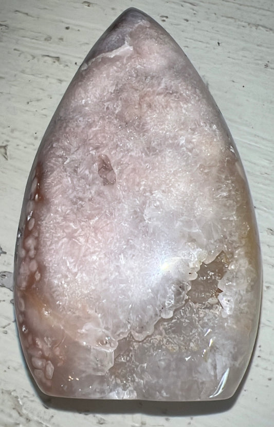 Polished flower agate crystal with a geode opening.