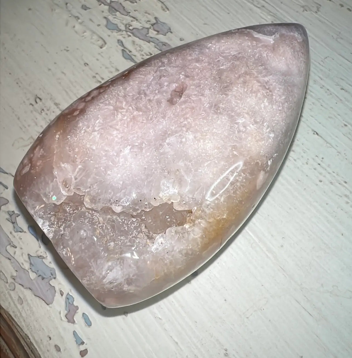 Pink Amethyst freeform with crystalline center on white surface