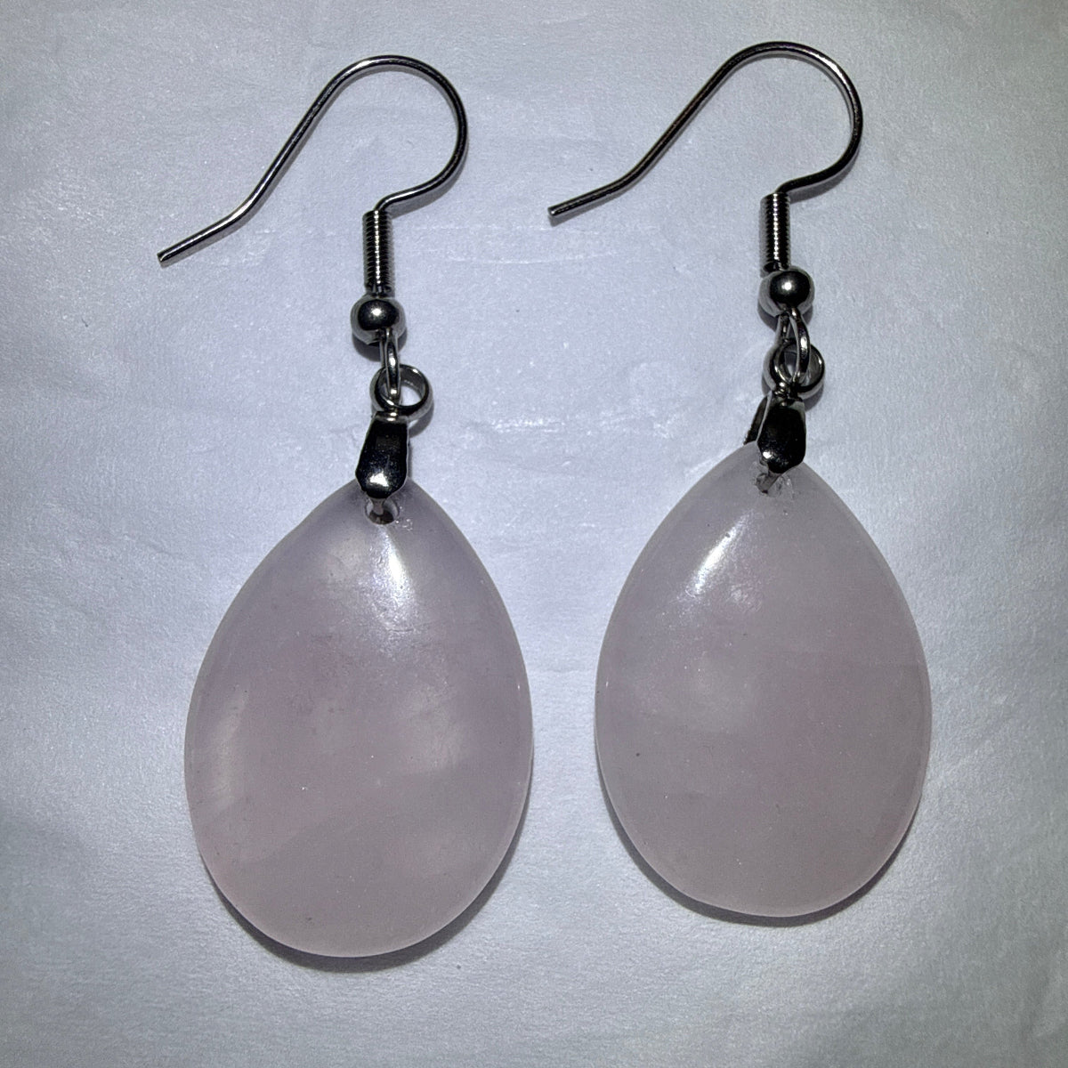 close up of a pair of rose quartz tear drop earrings