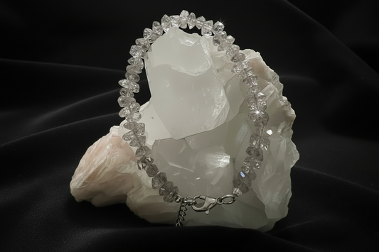 Herkimer Diamond Genuine Herkimer crystal bracelet with lobster claw clasp on a white rock with a black background