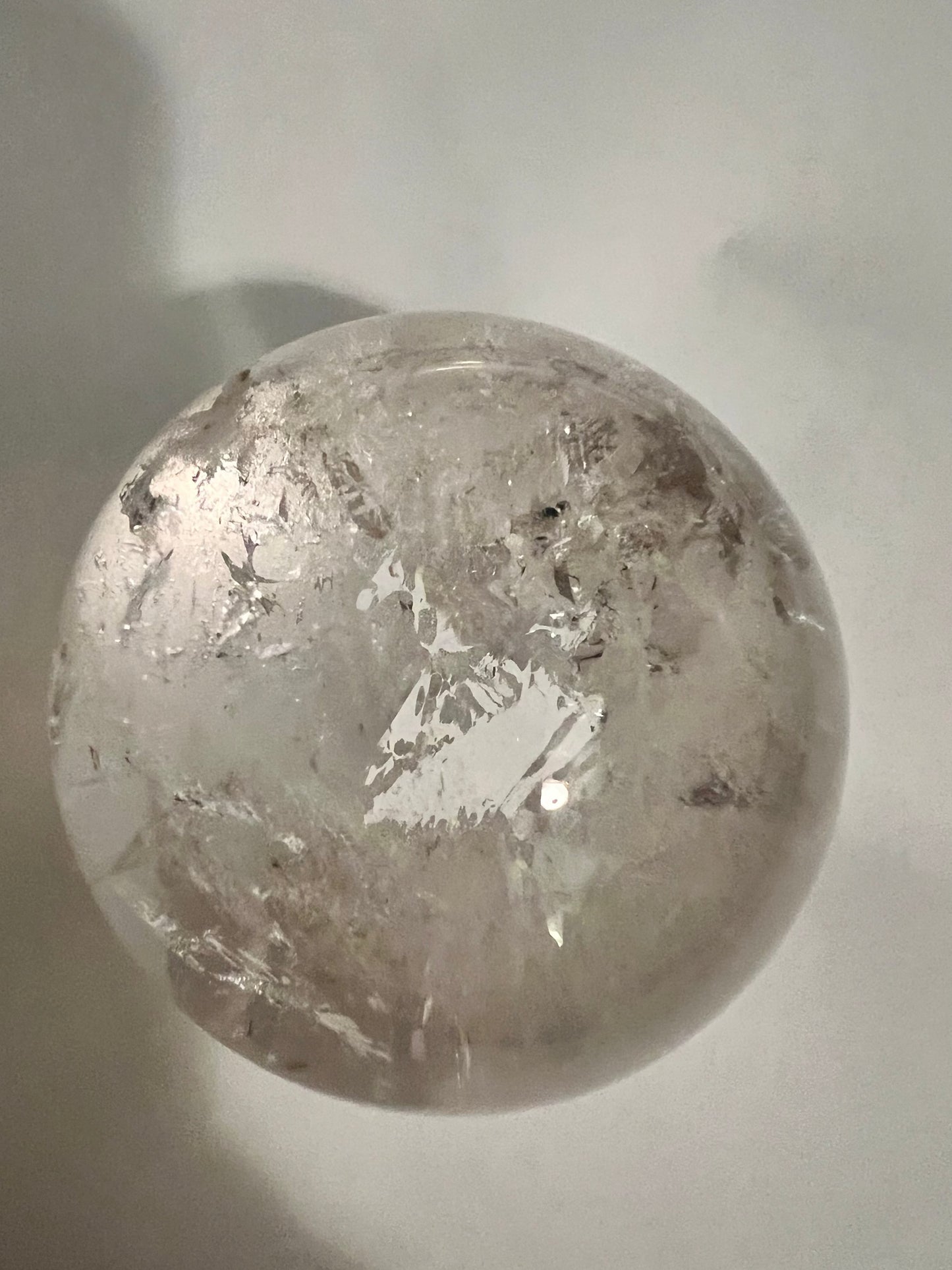 Clear crystal sphere with internal cracks.