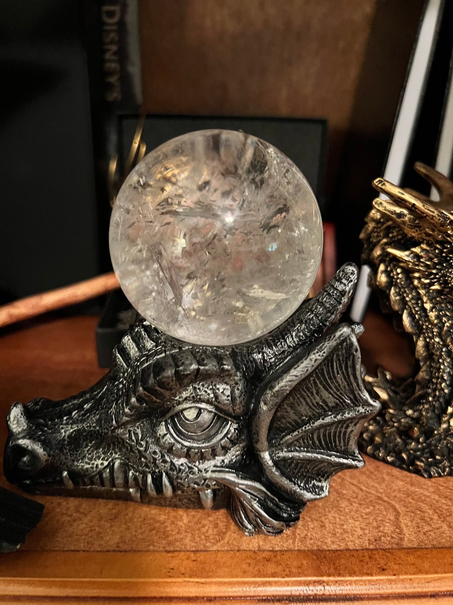 Dragon head statue holding a crystal ball.
