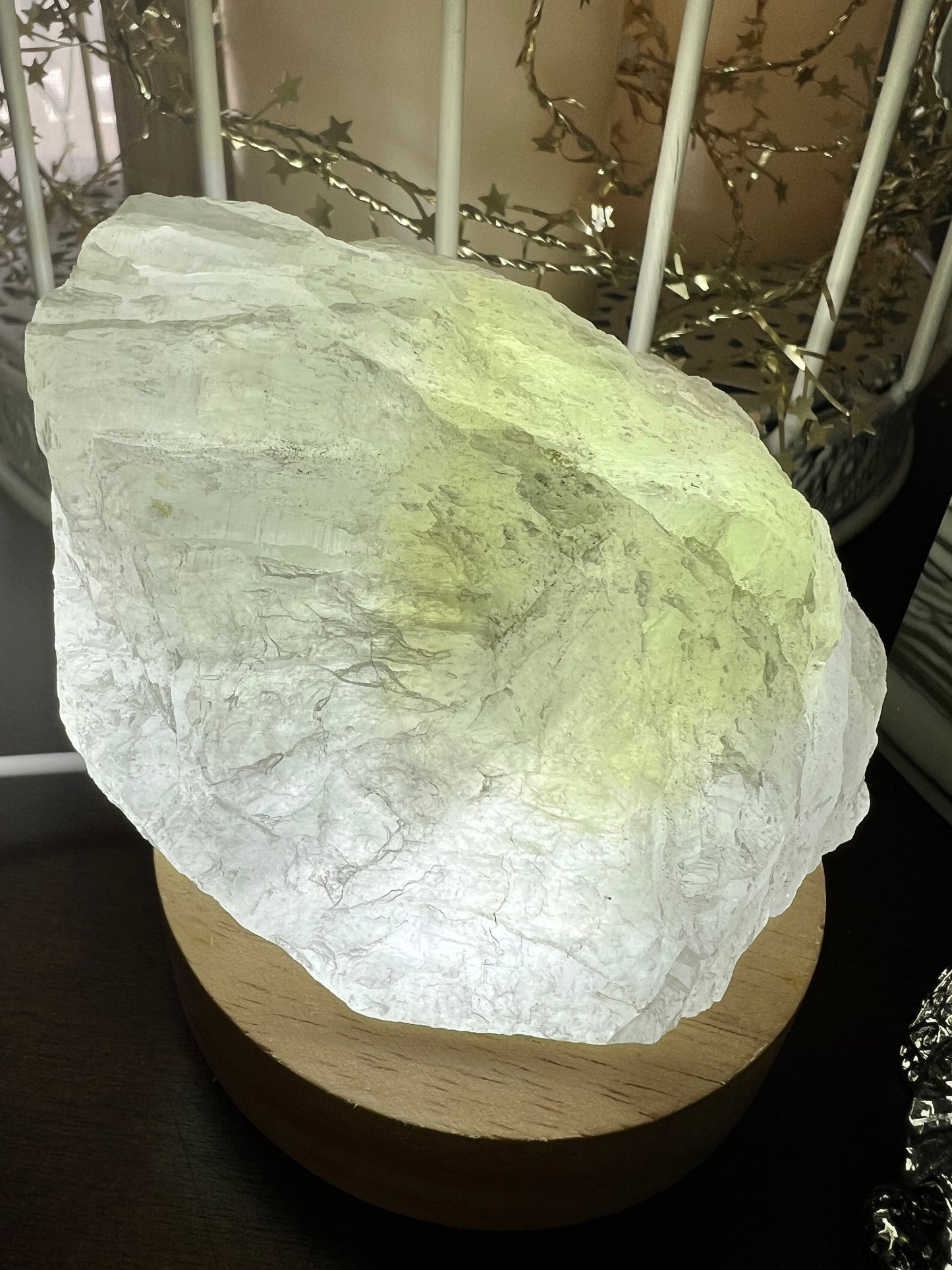 Translucent stone illuminated on a wooden base.