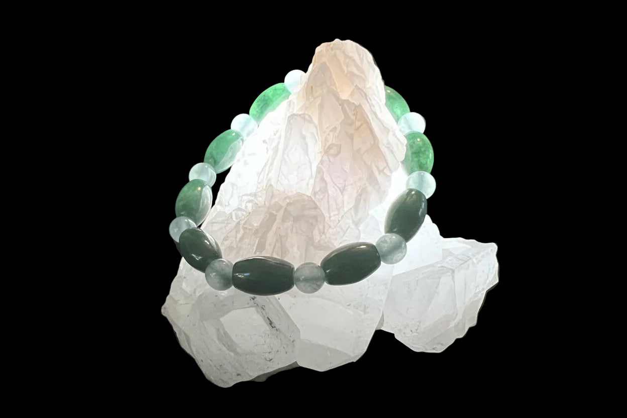 A beaded bracelet is draped over several white crystals.