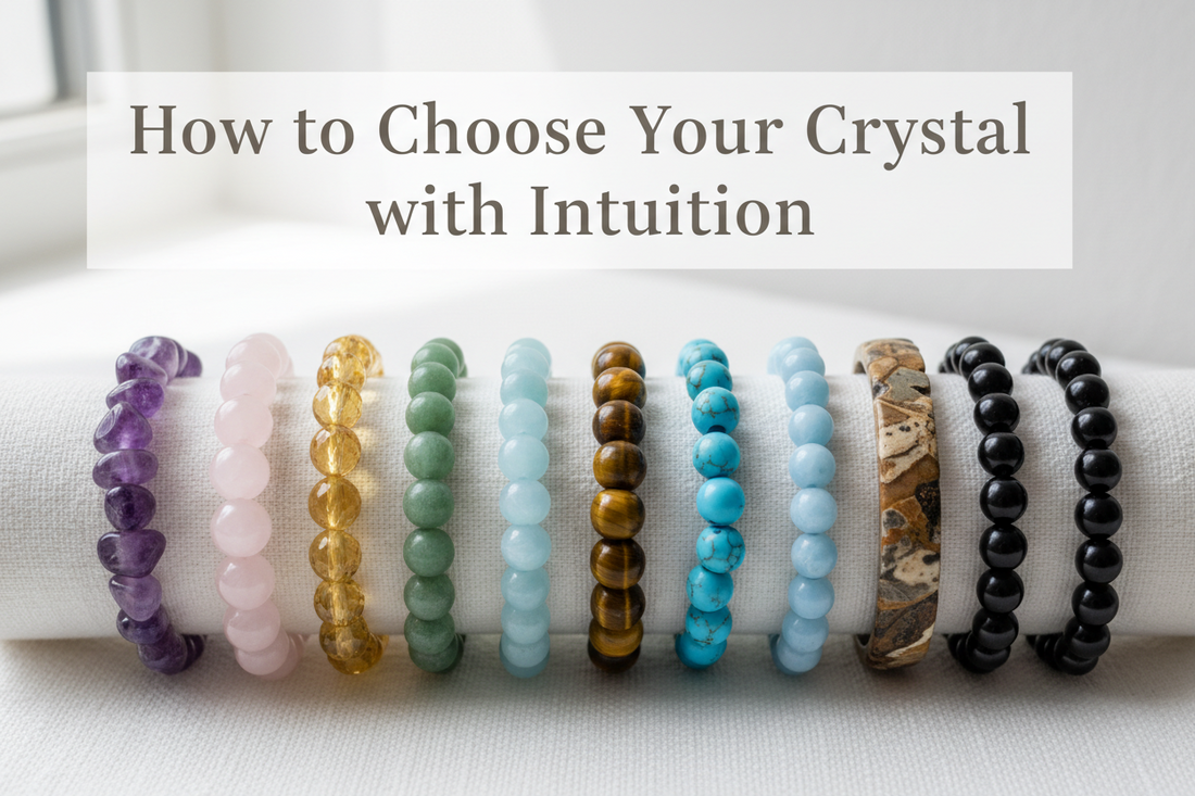 Row of crystal bracelets including amethyst, rose quartz, citrine, turquoise, angelite, Picasso jasper and black onyx on a white surface for intuitive crystal selection