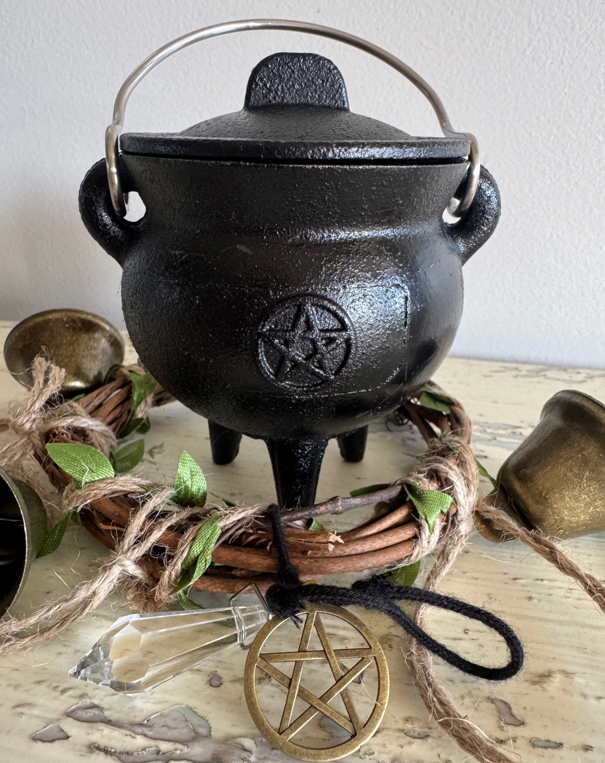 Black Wrought Iron Cauldron with an altar bell, and pentagon 