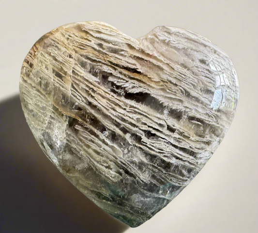 Heart-shaped crystal with layered textures.
