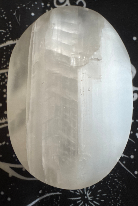 Oval, translucent, white selenite stone.