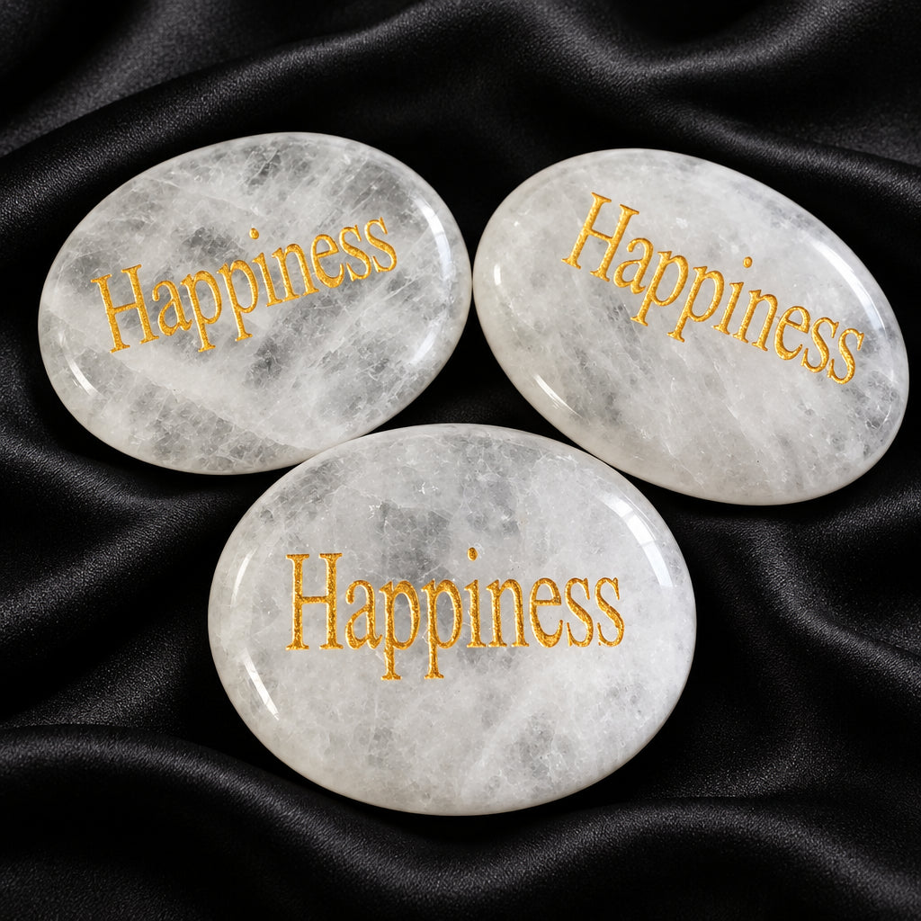 clear quartz carved worry stones with happiness etched in. a goldtone